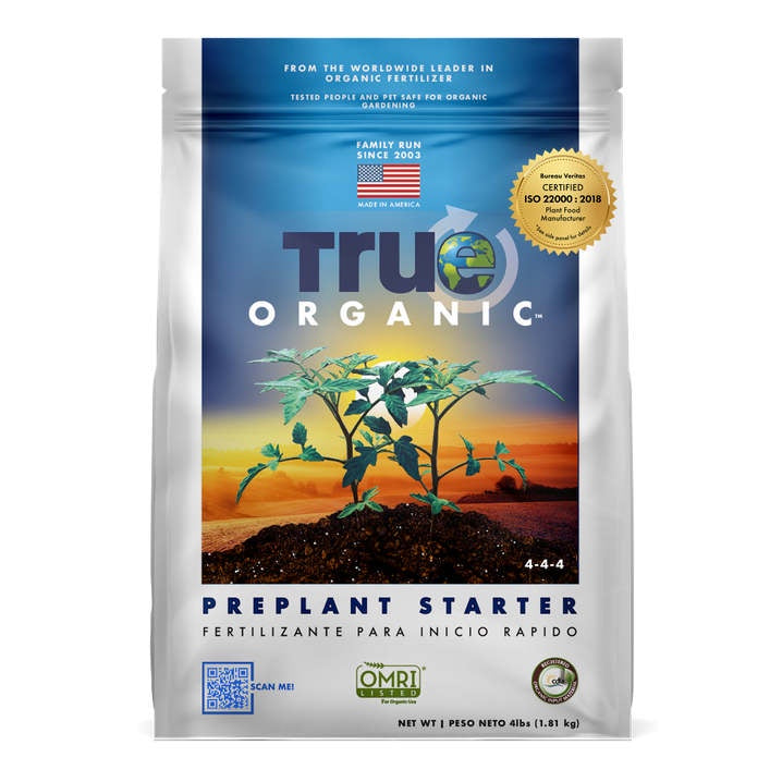 image of bag with true organic logo on a blue ground with an image of small tomato plants against a sunset on a light grey bag