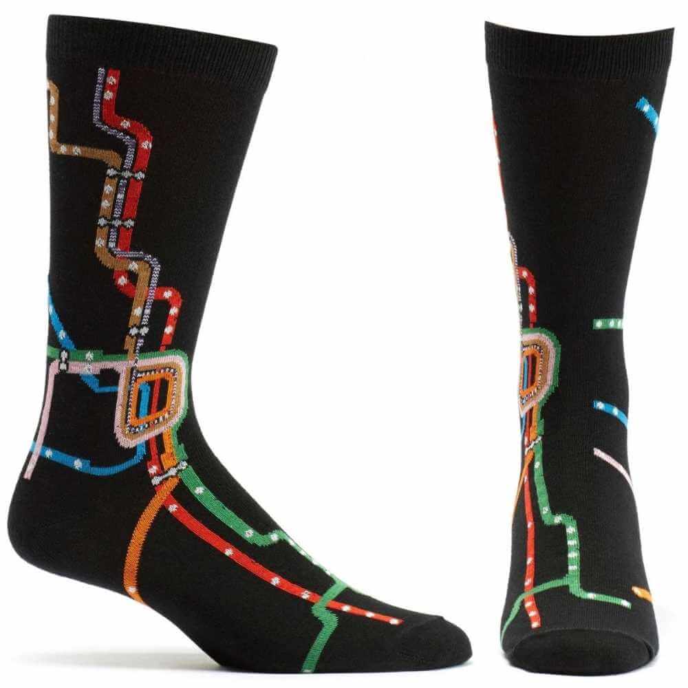 image of black socks on feet ---one from the side one from the front.  black socks with a colorful chicago transit map on them