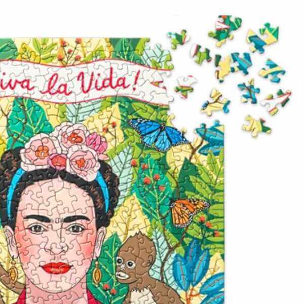 closeup image of part of jigsaw puzzle with Frida Kahlo her monkey and leaves in the background