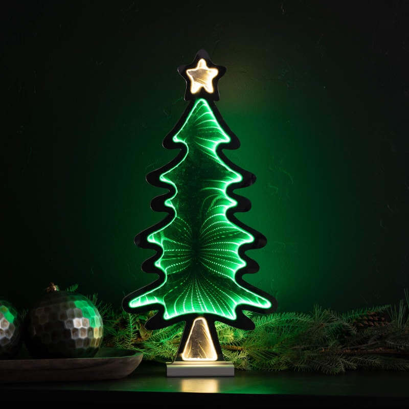 Decorative Christmas tree light with a star on top, glowing against a dark background.