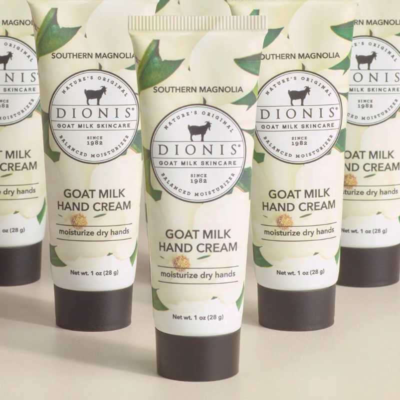 image of an upright tube with black lid in front of similar tubs with a photo of a magnolia on the tube behind the label