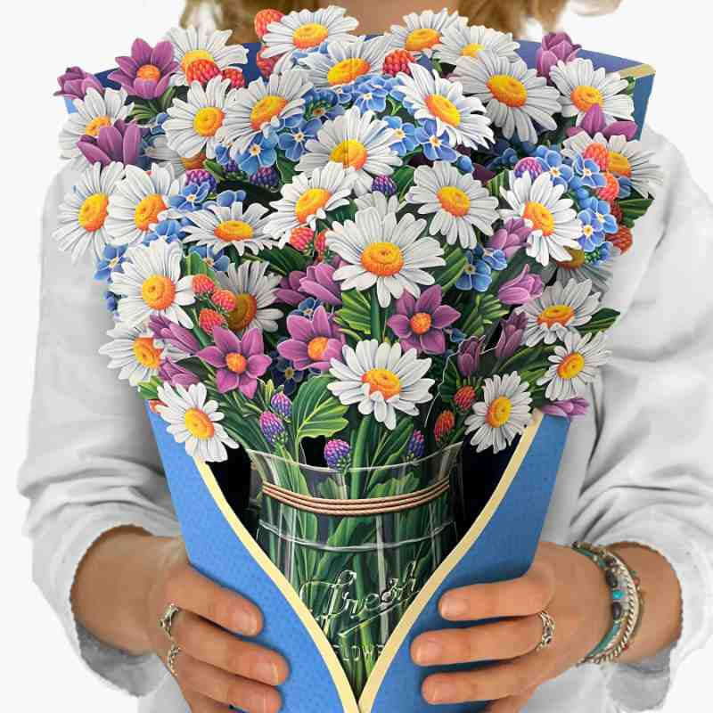 image of person holding a large paper bouquet of multi colored daisies in a base that resembles a mason jar
