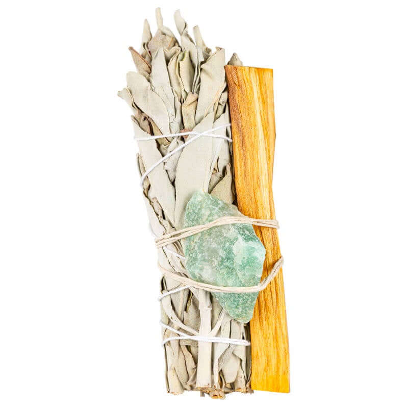 Bundled sage sticks with a crystal on a white background