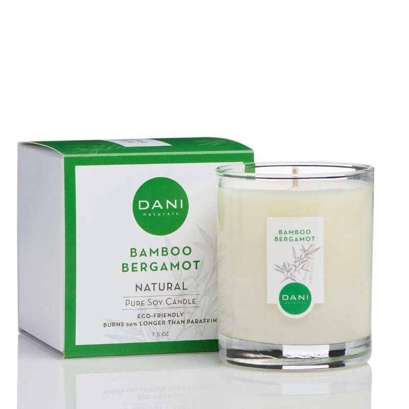 image of white candle in glass jar with white label and a square gift box with logo and candle scent in green on white