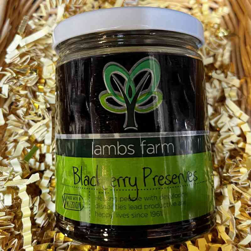image of glass jar filled with dark black preserves with a bright and dark green label
