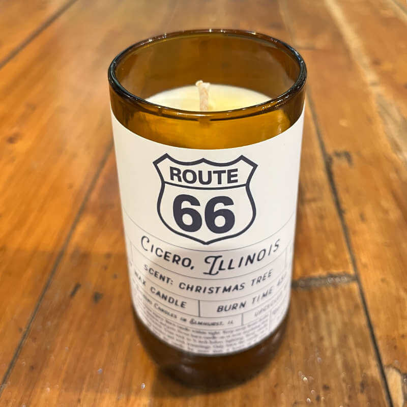 image of a candle in an amber glass jar with a white label sporting black Route 66 symbol and Cicero IL written on it