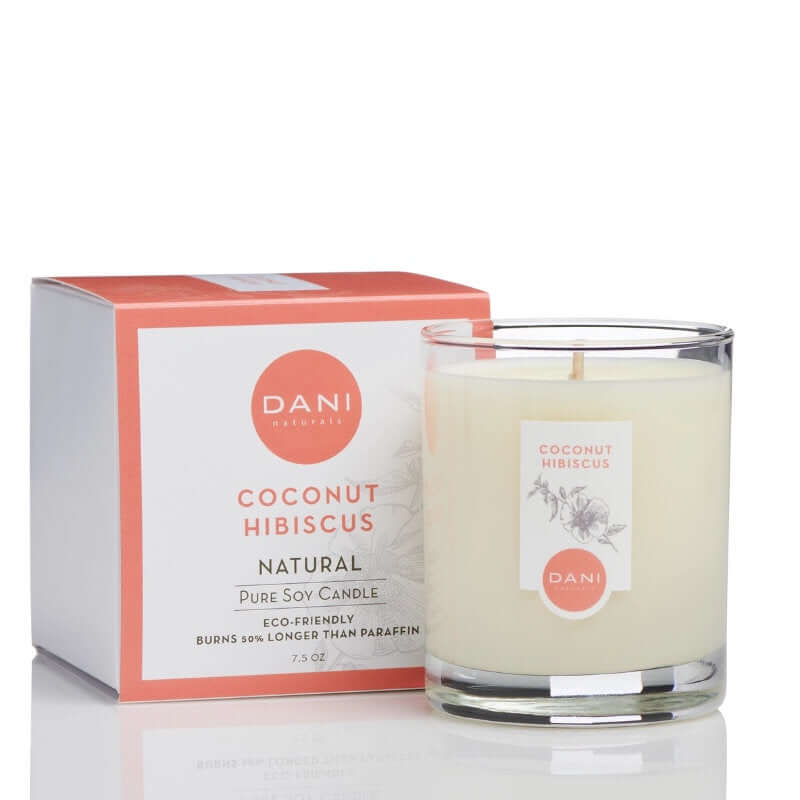 image of white candle in glass jar with white and peach colored label.  On the left is a square box in white with peach color logo and scent