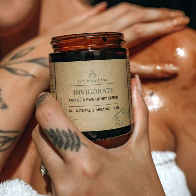 hand holding a brown glass jar with a natural kraft paper label