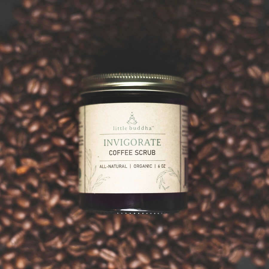 image of a round brown glass jar with light tan label sitting on a bed of coffee beans