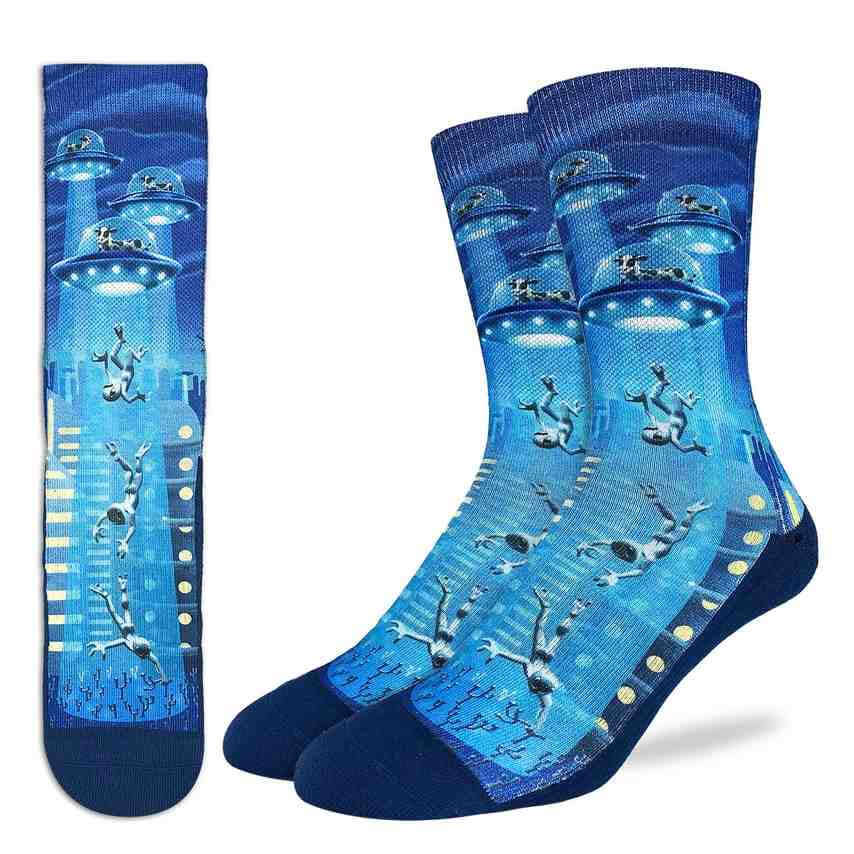 image of two feet with socks on the right, showing blue socks with aliens on the foot and cows in space ships above.  on the left is an image of the sock flat 