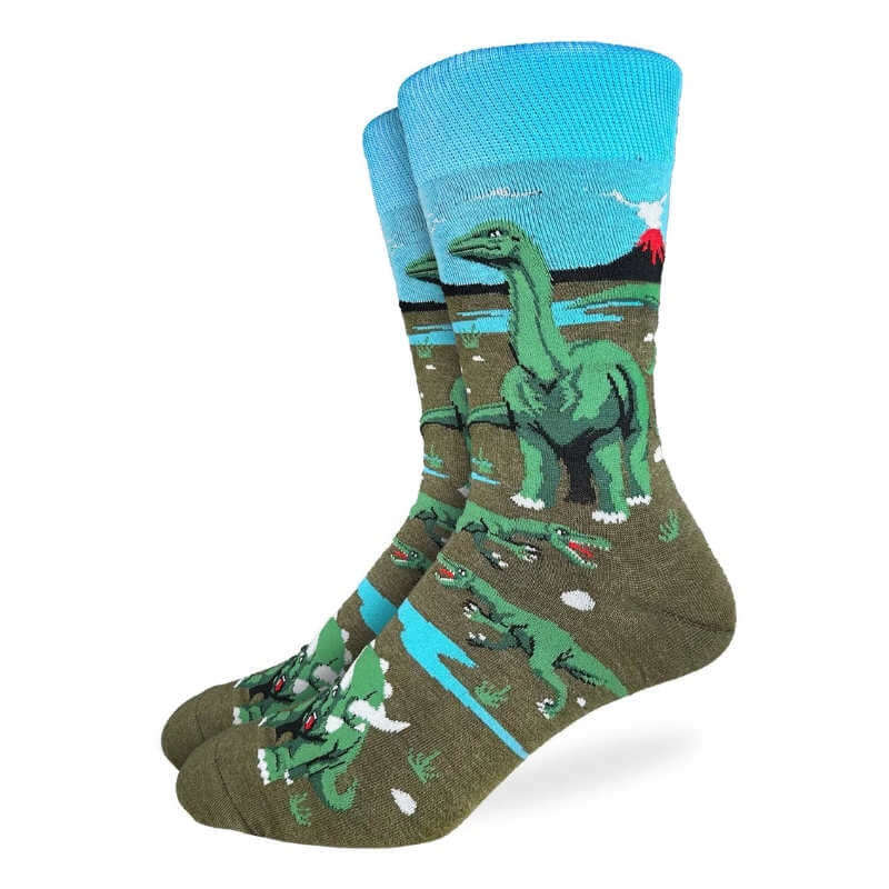 Dinosaur-themed socks with a blue sky and green landscape design on a white background