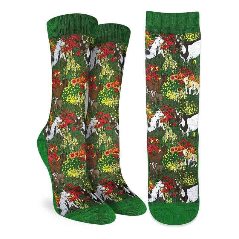 image of a pair of socks in green with drawings of black and white goats and different colored flowers
