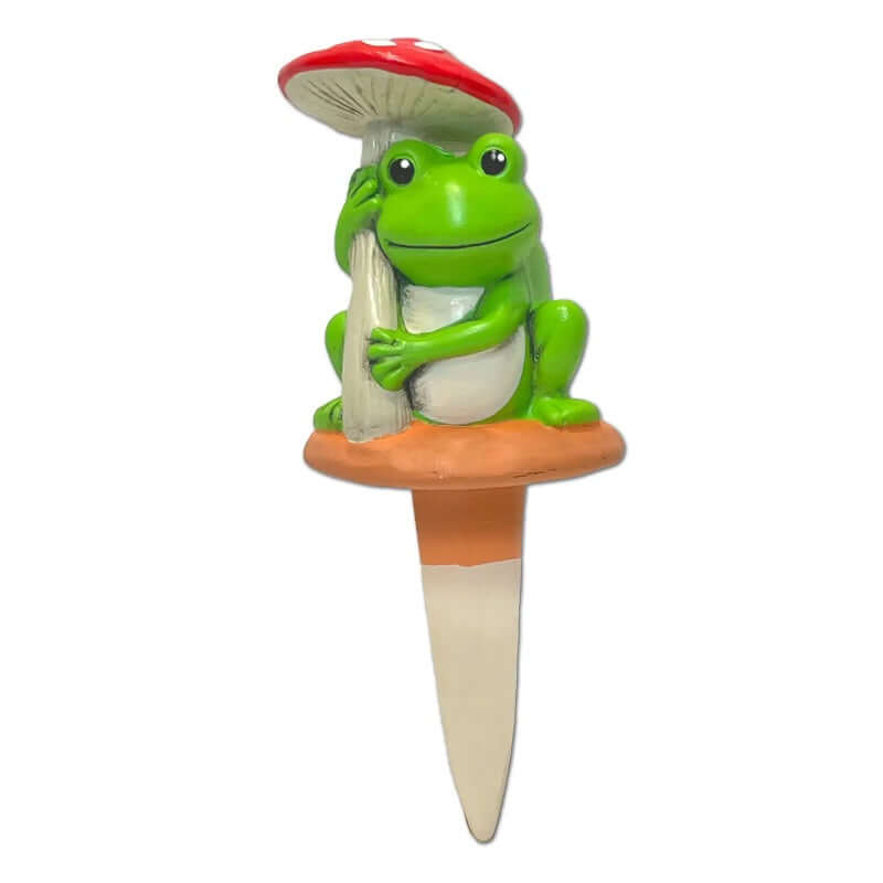 Garden ornament with a green frog holding a mushroom on a white background