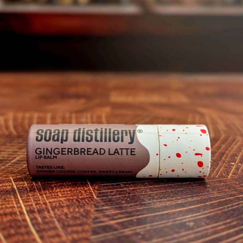 Soap Distillery Gingerbread Latte lip balm on a wooden surface