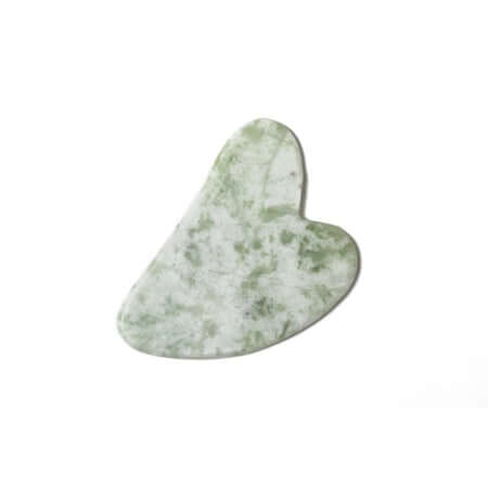 image of heart shaped white and jade colored flat stone sitting on a white towel