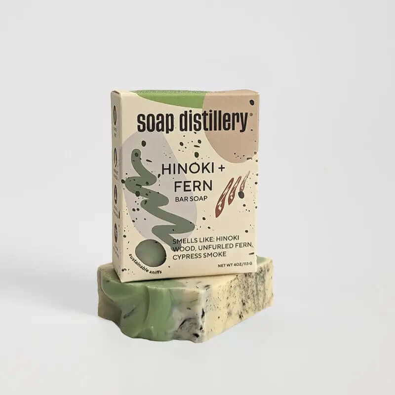 image of a box of soap with abstract shapes on it in grey tan and green with soap distillery logo and soap information