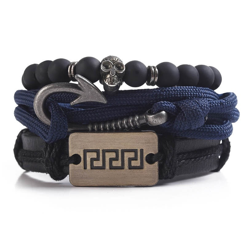Multibrand bracelet with black beads, blue ropes, and metal accents on a white background