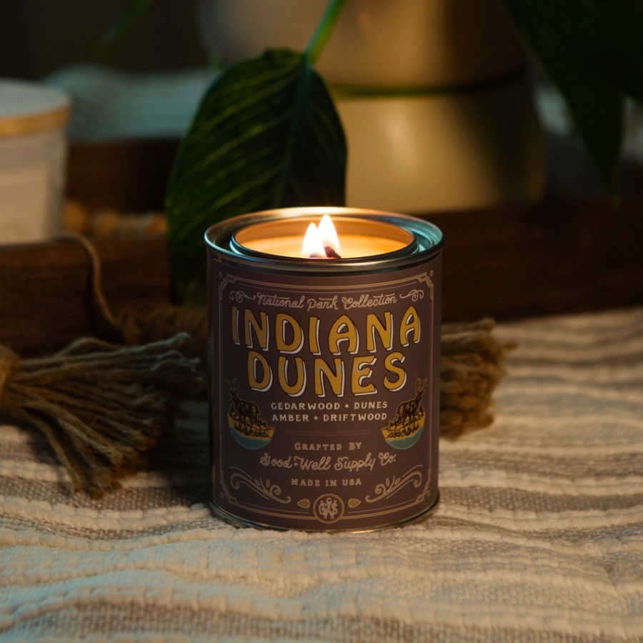 image of small round candle in can with brown label