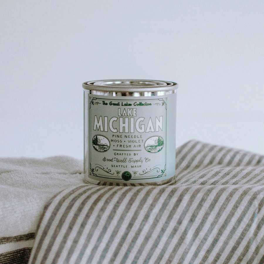 image of candle in round can with pale green label.
