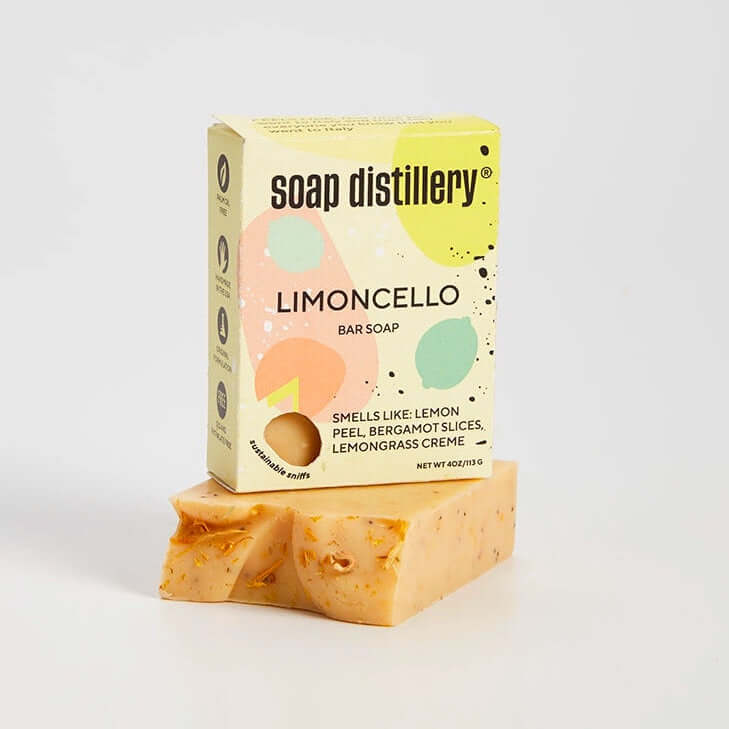 Bar of soap with a colorful box labeled 'Soap Distillery Limoncello' on a light gray background