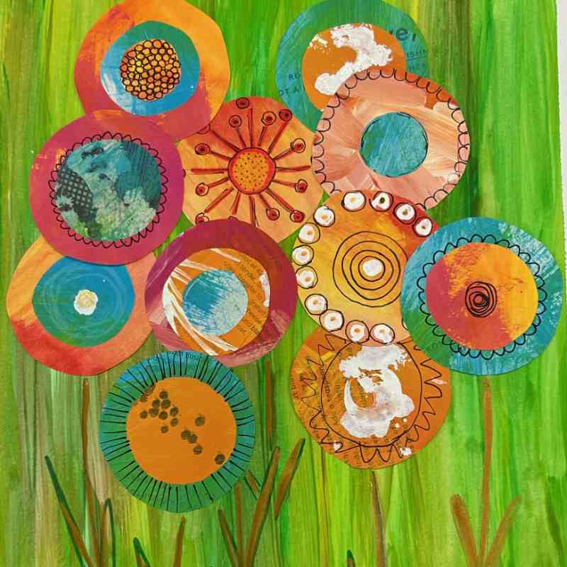 Colorful paper flower art on a green background