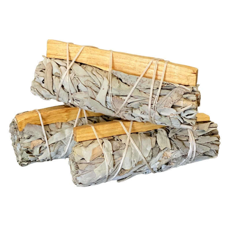 image of a stack of three grey sage bundles, each tied with a piece of palo santo wood