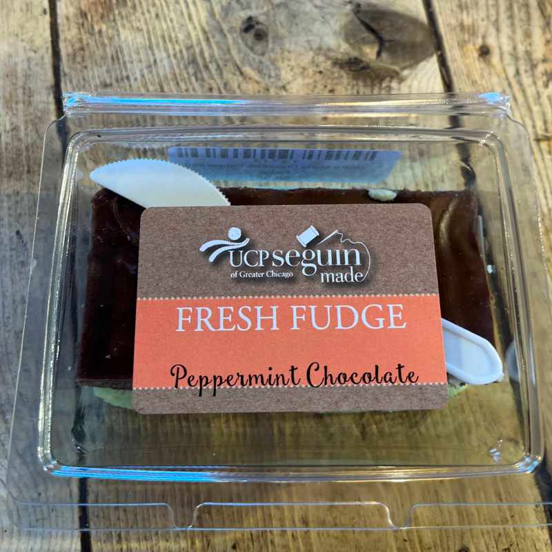 Packaged peppermint chocolate fudge with UCP Seguin label on a wooden surface