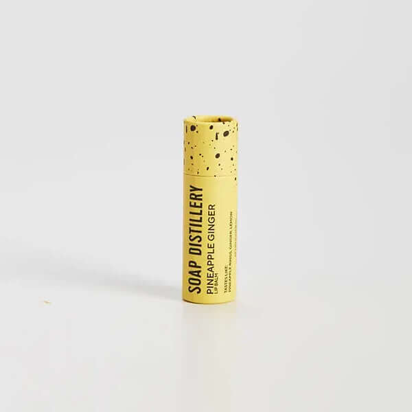 image of tube of lip balm in yellow with scent written in black