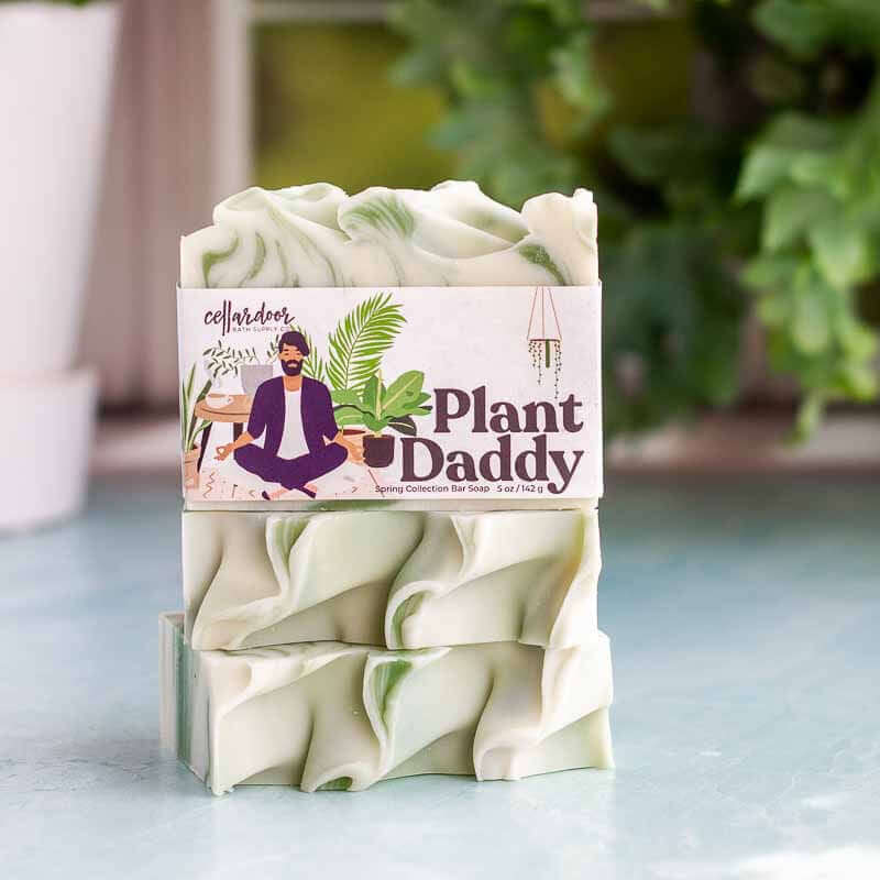 image of stack of 3 soaps with bumpy tops in cream and green color. Label says Plant Daddy and has a drawing of a man meditating