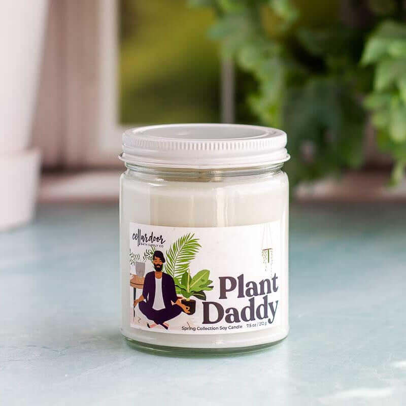 image of round clear glass jar with white lid and candle inside and a label with a drawing of a man with a beard meditating