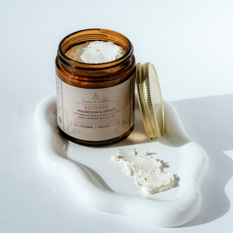 Jar of cream with a white lid on a white surface, featuring the brand 'Little Buddha'.