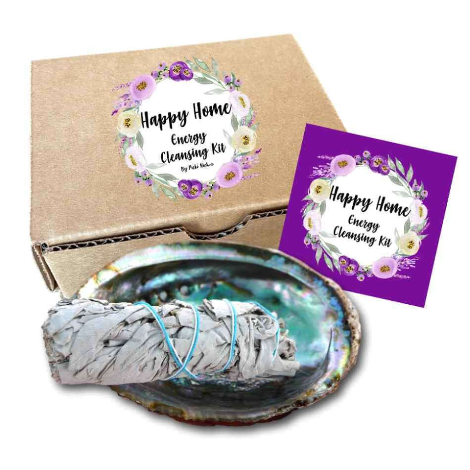 image of abalone shell with a bundle of white sage, in front of a cardboard gift box and a card that says happy home energy cleansing kit