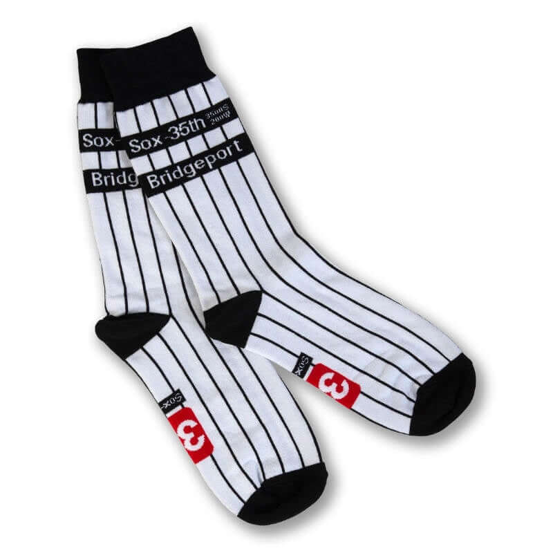 Pair of black and white striped socks with branding on a white background
