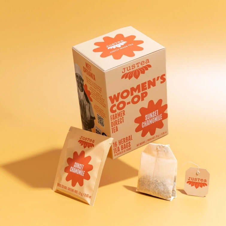 Justea Women's Co-op tea packaging on a yellow background