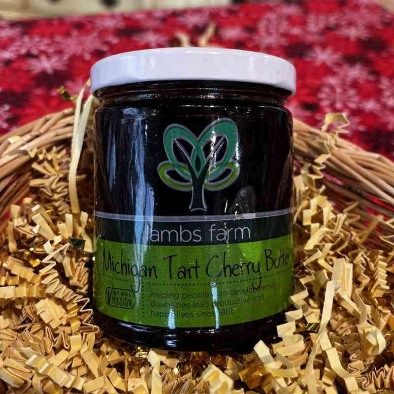 image of brown glass jar with white lid and green label with abstract green tree design