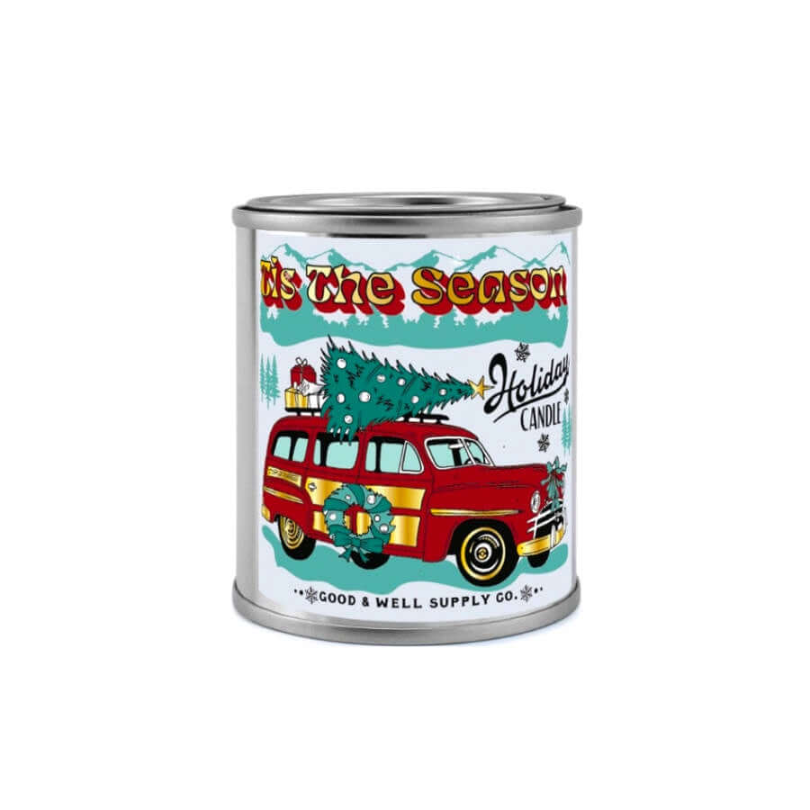 image of round candle in tin with a label showing a drawing of a vintage red car with a christmas tree on top and a wreath on the side
