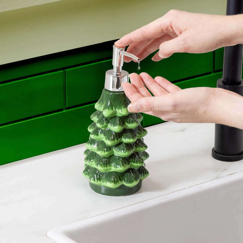 Tree-shaped soap dispenser being used in a kitchen setting