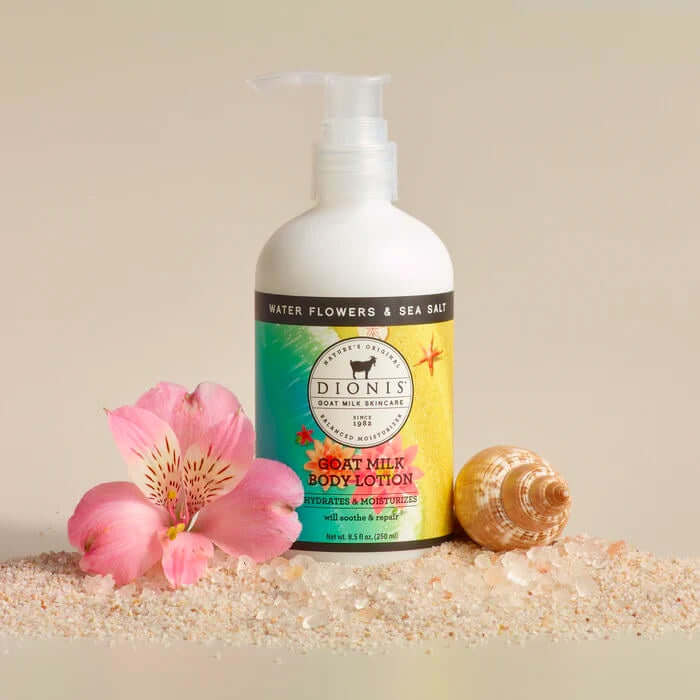 image of white bottle with plunger top and label in greens and yellows with drawing of flowers.  Surrounded by a seashell and an orchid blossom and a spray of sea salt