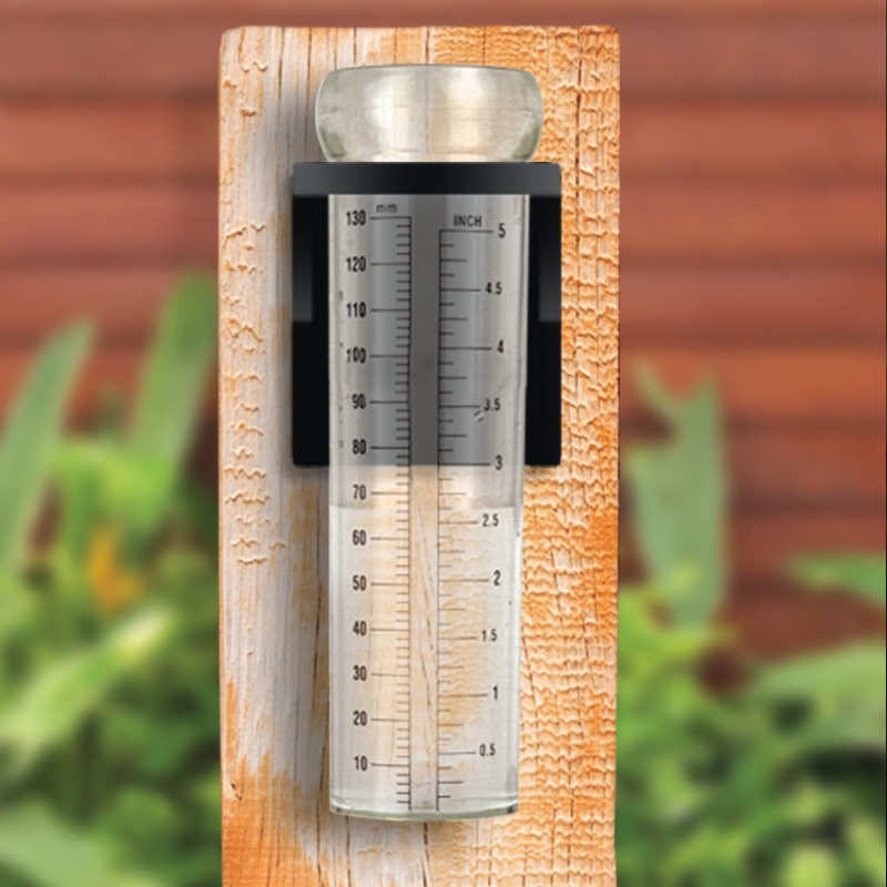 image of rain gauge mounted on a board outdoors