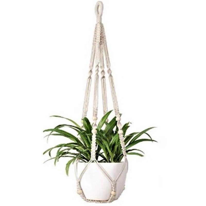 image of white cotton woven macrame style plant hanger with white bead accents, holding a white ceramic pot with a spider plant in it.