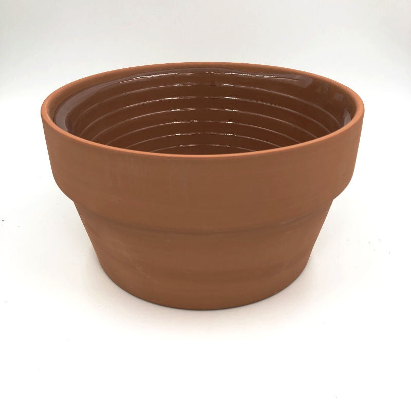 round clay pot with plastic liner