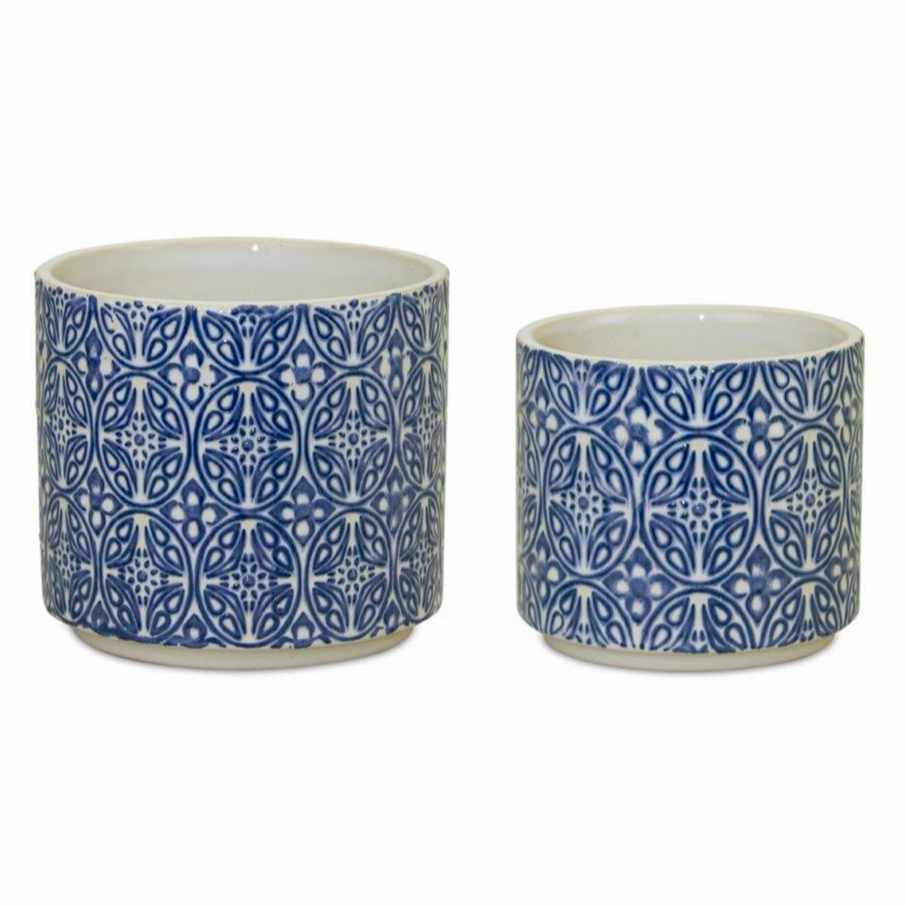 photo of large and small white ceramic pots with delicate blue filigree design on the outside