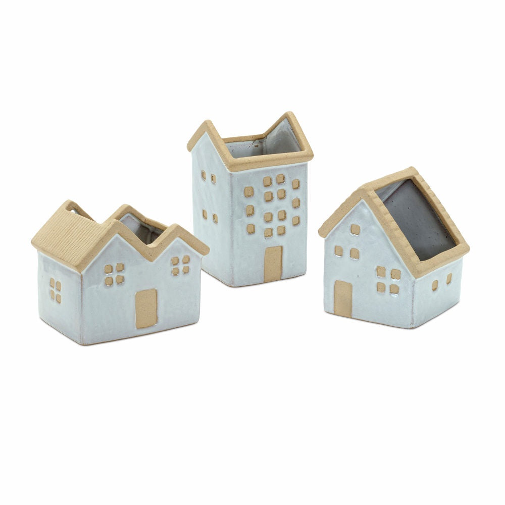 image of 3 ceramic planters in the shape of houses.  They are white with tan accents.  One house has two peaks, another is tall with one peak, and the third is medium height with a single asymmetrical peak