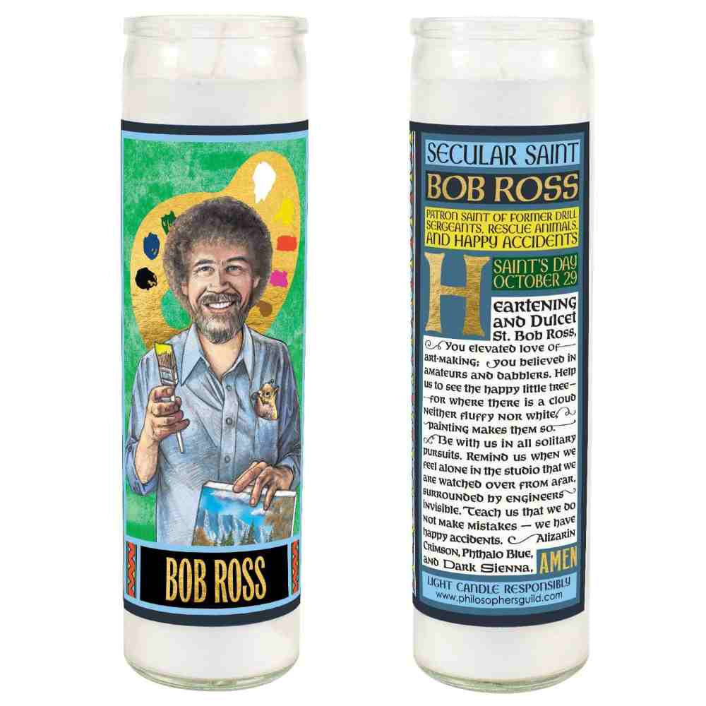 image of two tall narrow candles.  One the left is the front with a drawing of Bob Ross holding a paint brush.  On the back is the detailed description and prayer written in black on white
