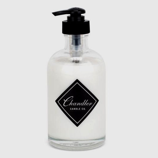 glass jar with black pump top, black Chandler logo, filled with white hand lotion