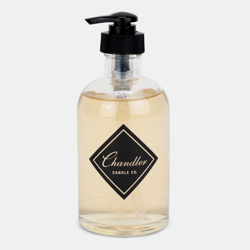 glass jar with black pump top, black Chandler logo, filled with clear liquid soap