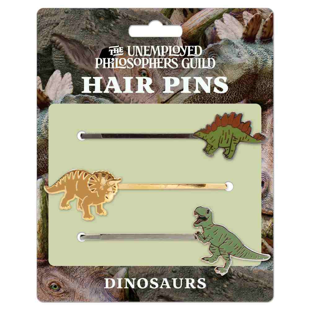 image of a card with dinosaur photos in the background, and three hair pins on the card, each with a different dinosaur on the end