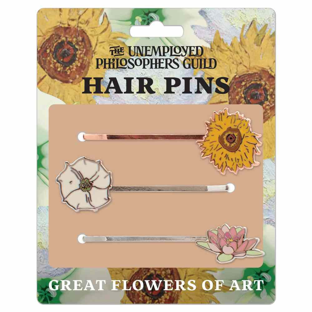 image of card holding three hair pins.  background of card has drawings of sunflowers.  One pin has a yellow sunflower, one has a white gardenia and one has a pale pink water lily