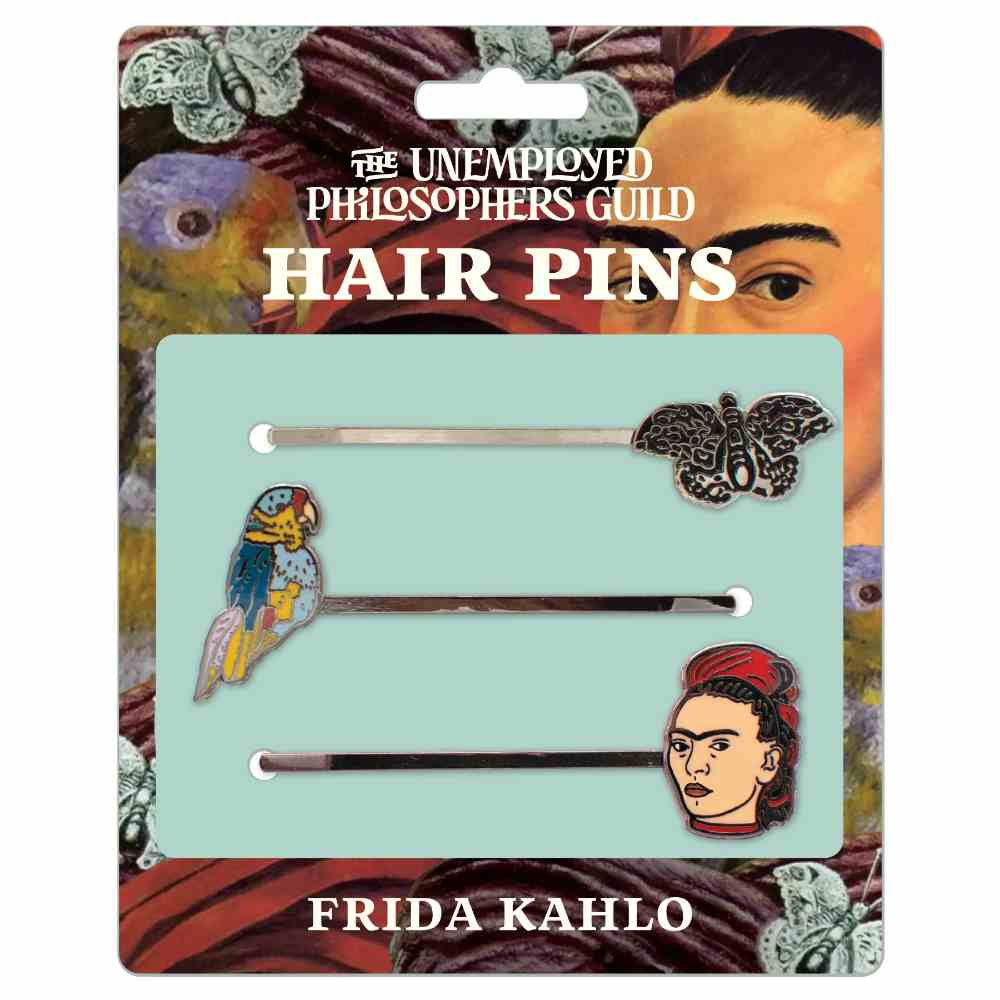 image of card with painting of Frida in the background, with three hair pins on the front, one with a butterfly, one with a parrot, and one with a face of Friday Kahlo
