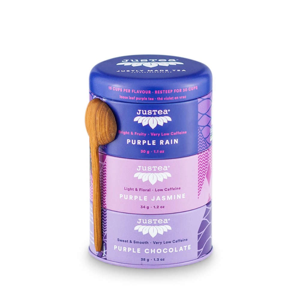 image of stack of three interlocking round tea tins in three different shades of purple, with a wooden spoon attached.  Logo and text in white and darker purple